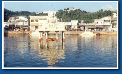The saravana poigai tank and the temple atop the thiruthani hills
